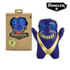 A purple Fuggler Ugly Monster plush toy with large teeth and a gold collar is shown next to its packaging.