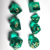 A collection of seven translucent green acrylic polyhedral dice arranged against a white background.