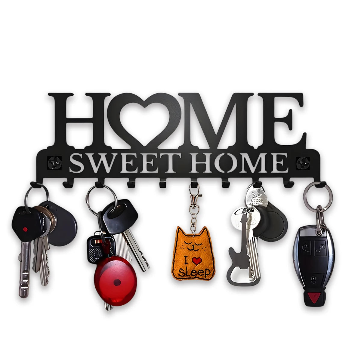 رف مفاتيح حائط باللون الأسود المطفي مع لافتة مزخرفة تقول "HOME SWEET HOME"