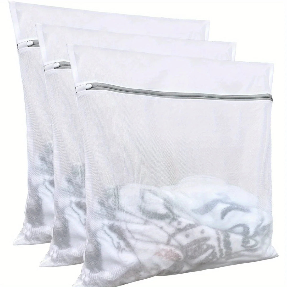 Three white reusable mesh laundry bags with gray zippers stacked together