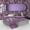 A display of purple and pink marble self-adhesive wall stickers or tiles stacked on a white counter in a bathroom setting.