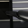 Close-up view of black carbon fiber rear mudguards for a Sur-Ron S/X electric vehicle.