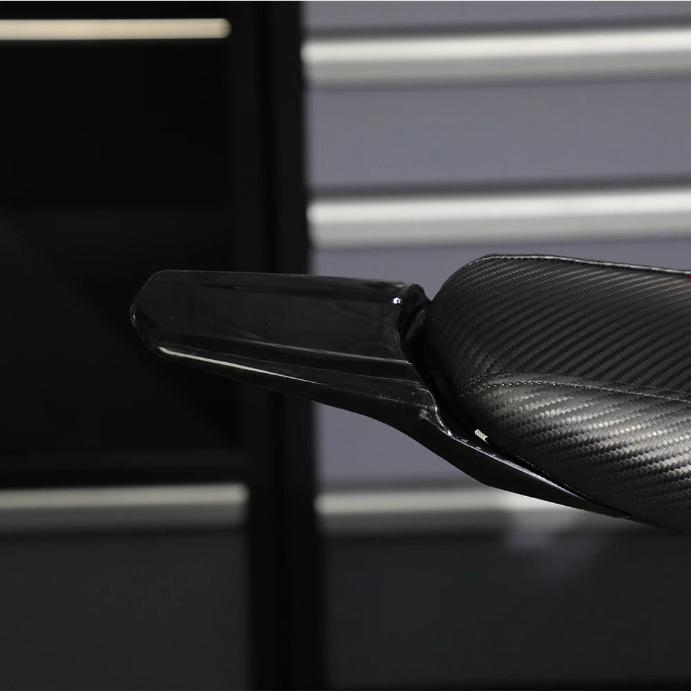Close-up view of black carbon fiber rear mudguards for a Sur-Ron S/X electric vehicle.