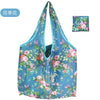A light blue floral nylon reusable shopping tote bag with pink and green flowers.