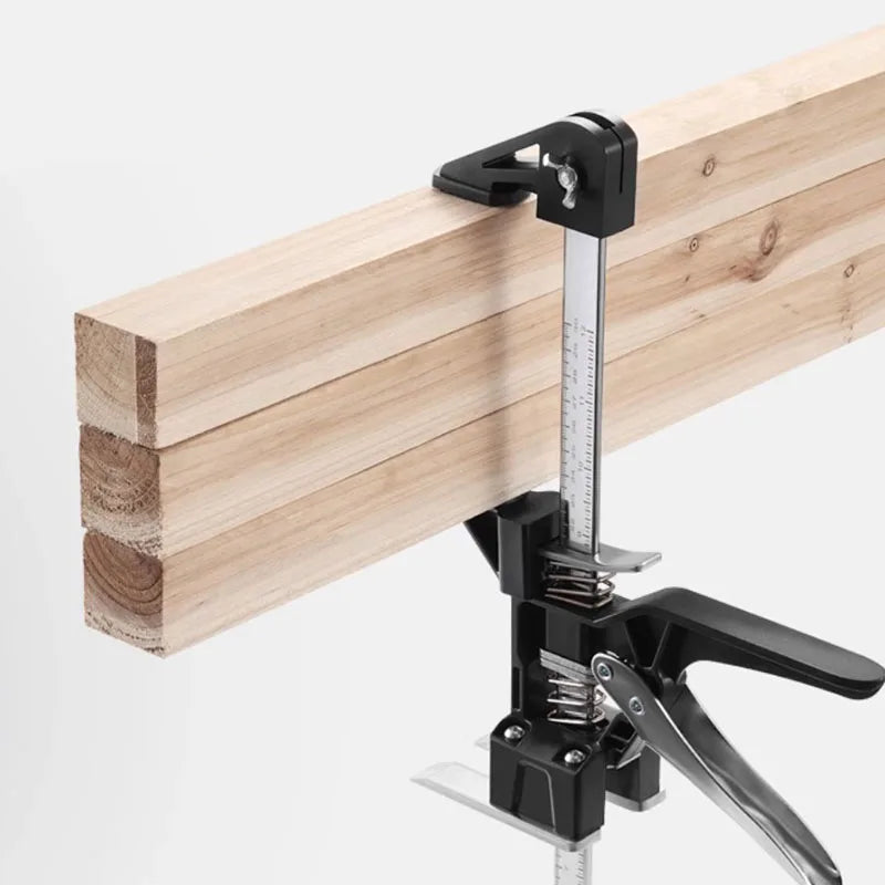 A black heavy-duty furniture installation lifting bracket with a metal ruler attached to a wooden plank.