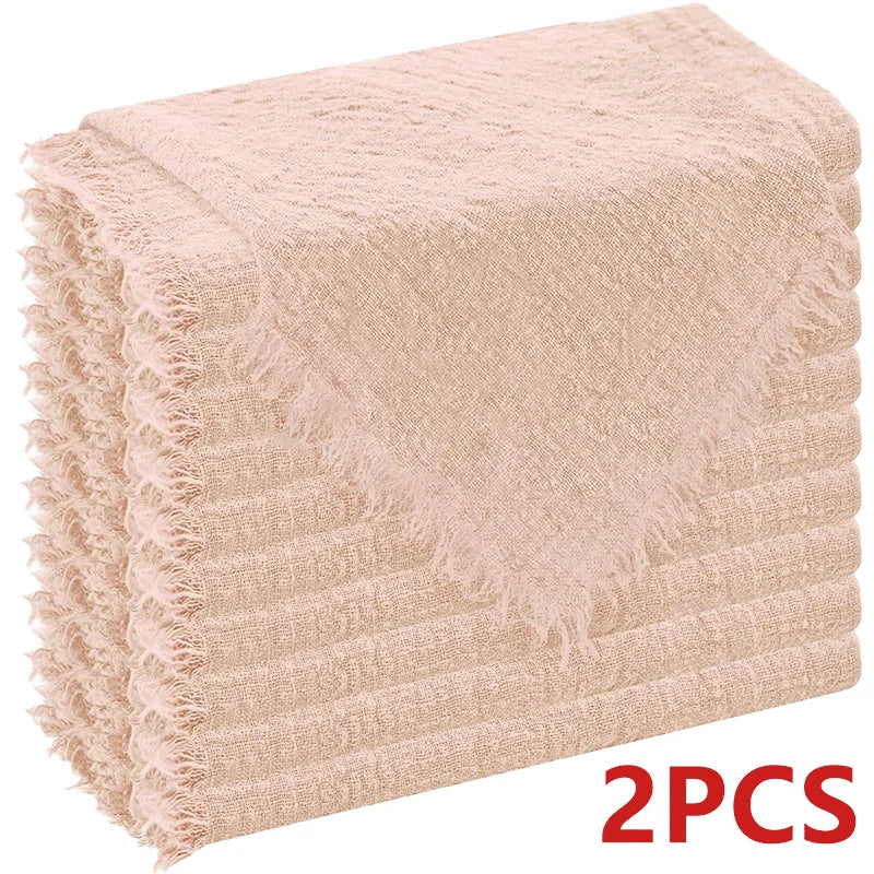 A stack of six raw-edge, light pink polyester cloth napkins.