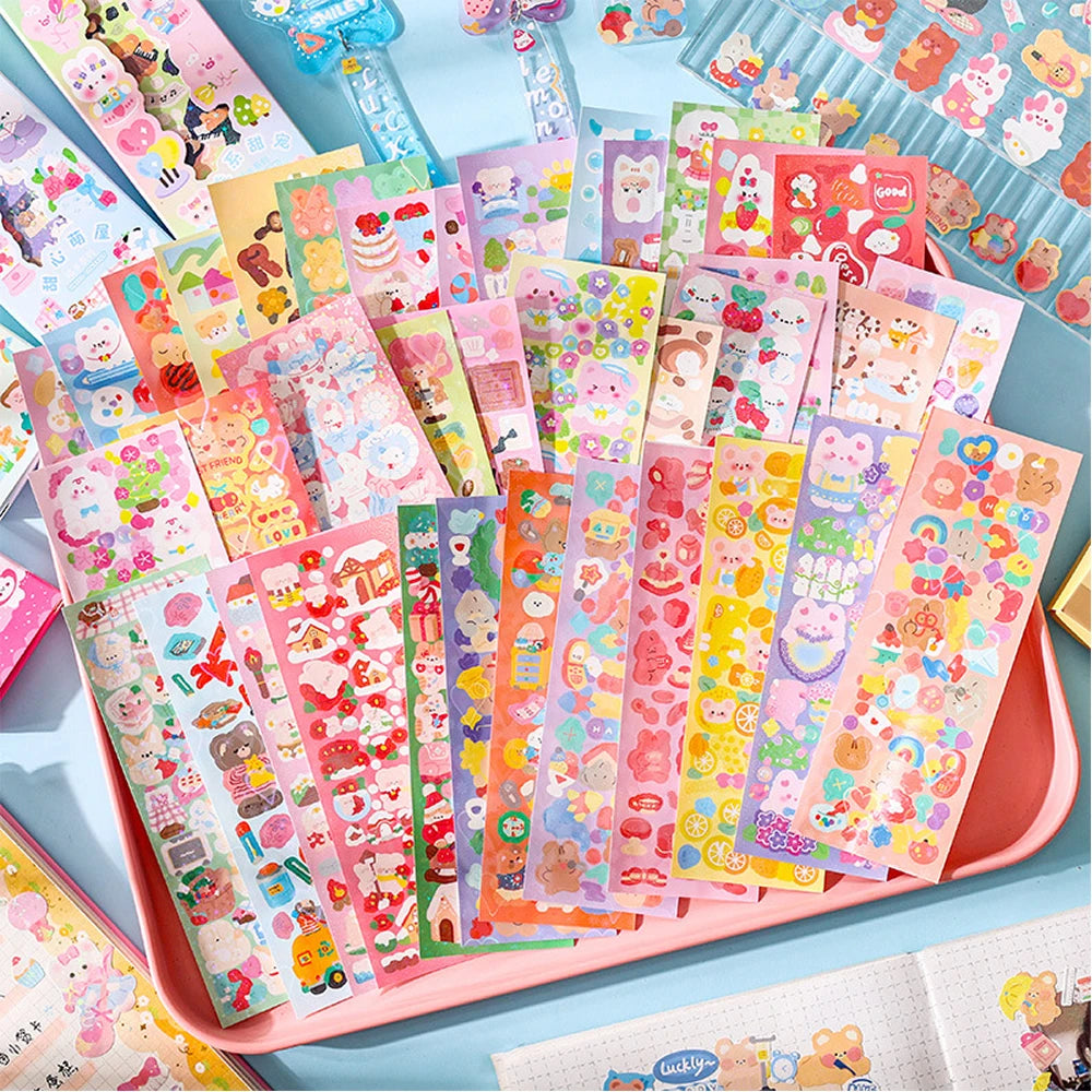 A colorful assortment of kawaii stickers for journaling and crafts displayed in a pink tray.