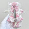 A pink and white decorative utility cutter shaped like a cat paw with a ribbon bow and a cross detail.