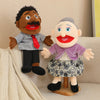 A hand puppet set featuring two characters, a dark-skinned man and a white woman, used for storytelling and role play.