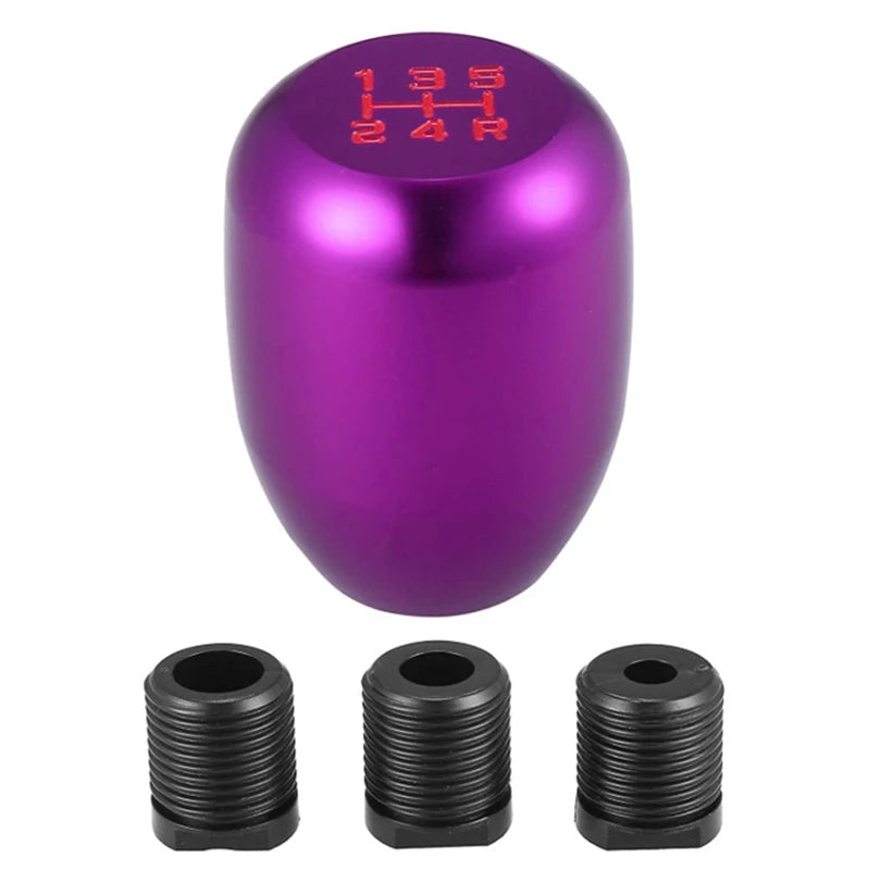 A purple aluminum gear shift knob with markings and two black adapters shown next to it.
