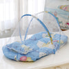 A foldable baby mosquito net is shown spread over a mattress with a pillow, ready for use.