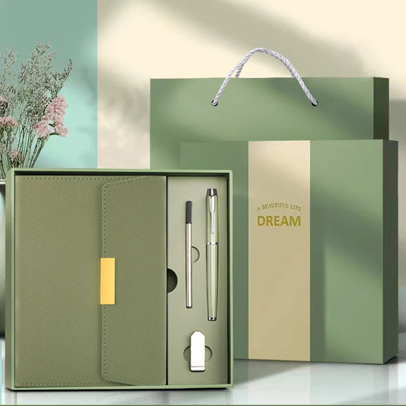 A green leather journal notebook with a matching box and grooming tools displayed on a light surface.