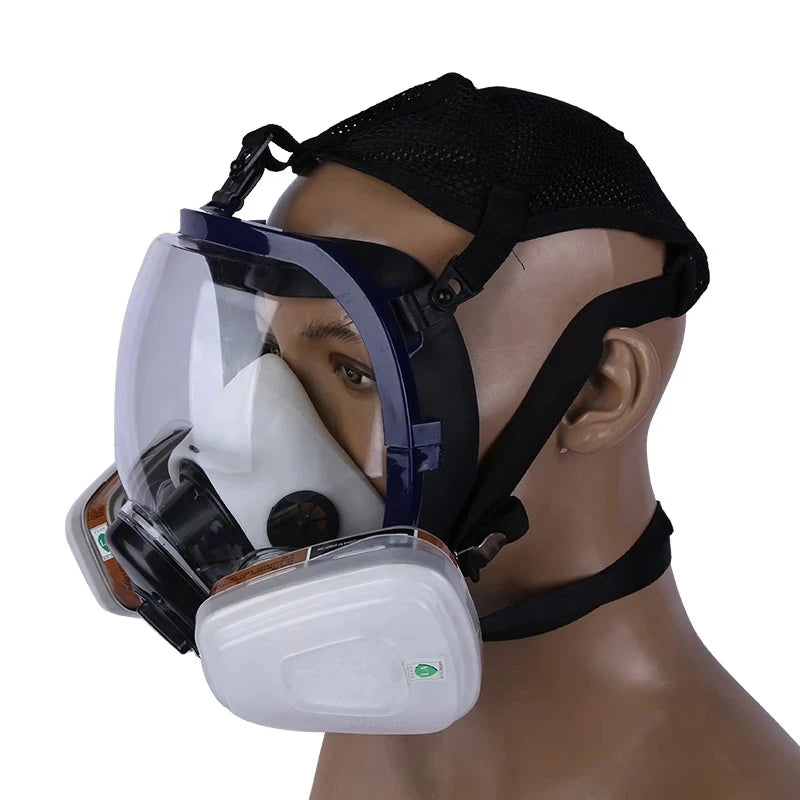 A full face respirator mask with a clear visor and white filter is shown on a mannequin head.