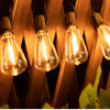 A close-up of warm glowing solar string lights hanging on wooden slats.