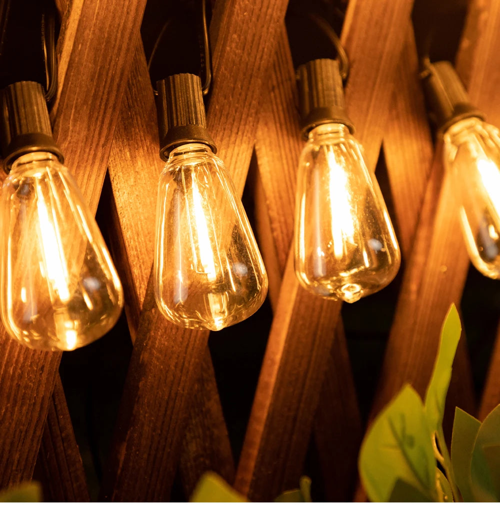 A close-up of warm glowing solar string lights hanging on wooden slats.