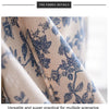 Close-up of a beige cotton-linen curtain fabric featuring a blue retro floral pattern.