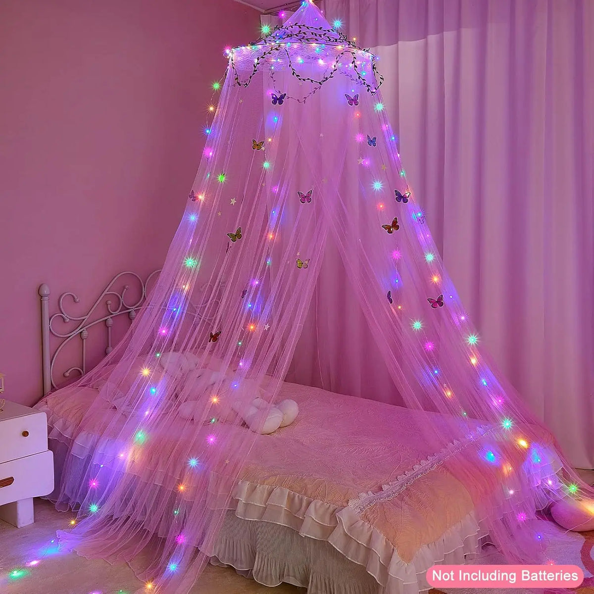 A pink sheer dome mosquito net with LED lights draped over a bed for a whimsical atmosphere.