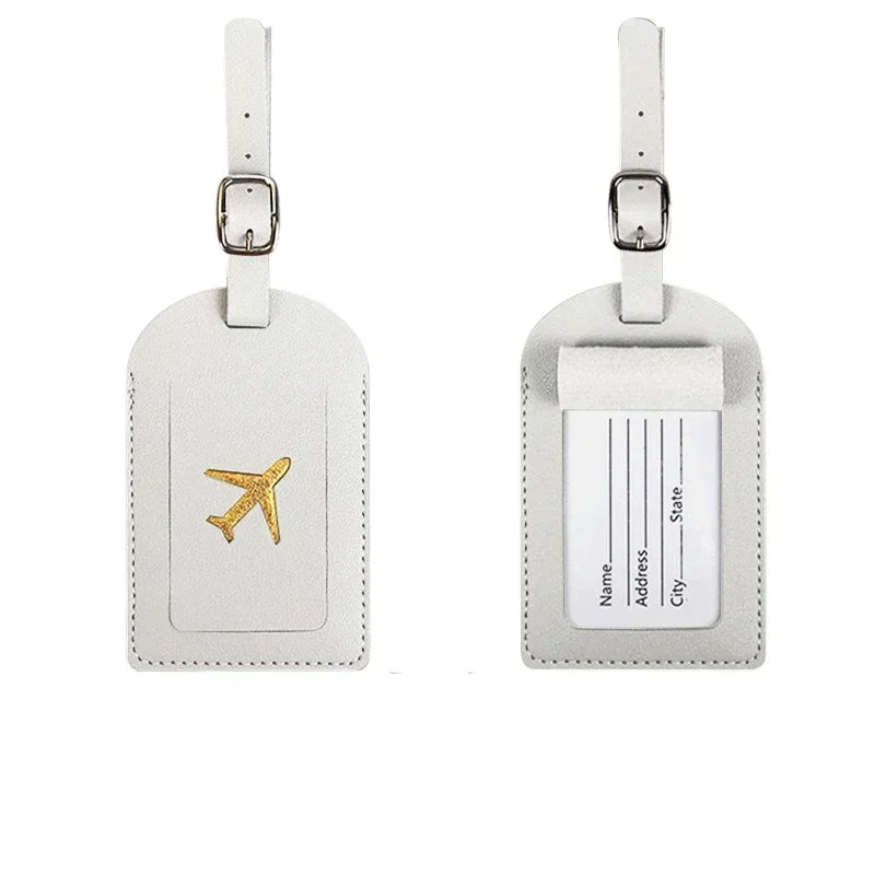 A light beige PU leather luggage tag with a rectangular design and a gold airplane emblem.