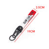 Red and white nylon keychain with a steel clip and text on the strap