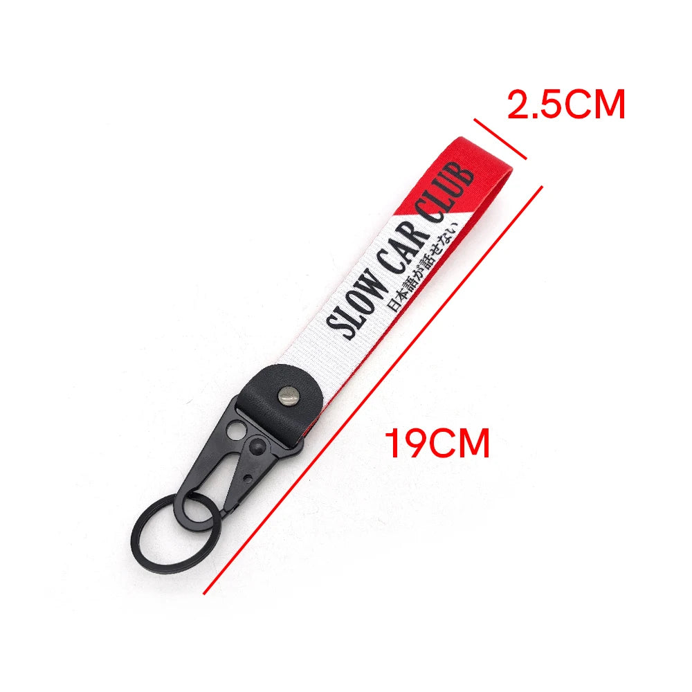 Red and white nylon keychain with a steel clip and text on the strap