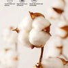 Close-up of fluffy white cotton batting inside a brown quilted duvet cover and pillowcases.