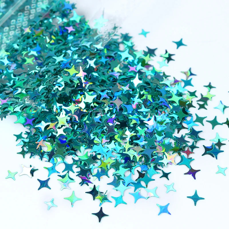 A pile of iridescent teal and green holographic star sequins for resin crafts.