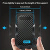 A hand is pressing a black phone mount with a textured surface to pop out the length of the support.