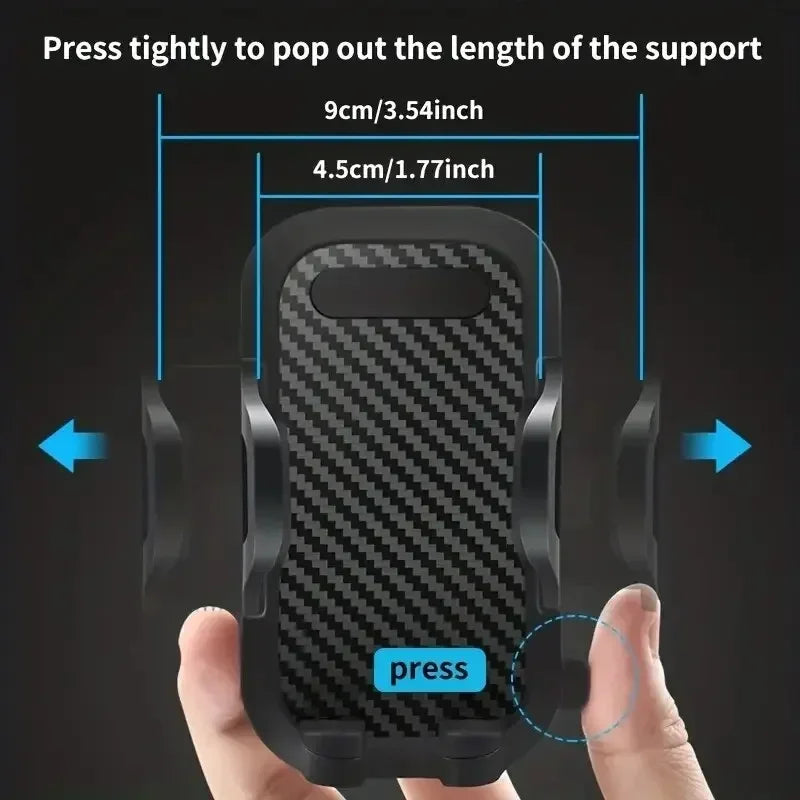 A hand is pressing a black phone mount with a textured surface to pop out the length of the support.