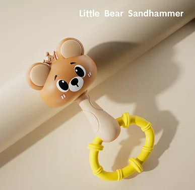 A cute little bear sandhammer toy with a yellow ring, shown in a close-up on a light background.