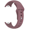 A close-up view of a mauve silicone replacement strap for a fitness tracker, showing the buckle and strap design.