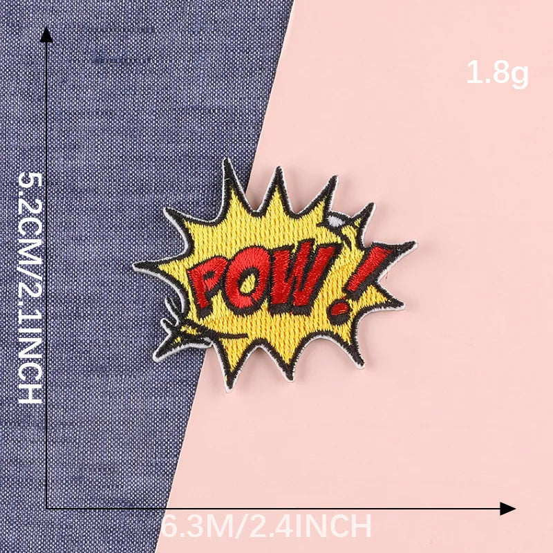 Yellow embroidered lettering patch with POW! text on a gray fabric background