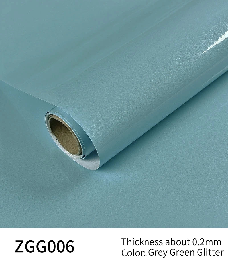 Roll of Grey Green Glitter peel-and-stick vinyl contact paper shown from the side.