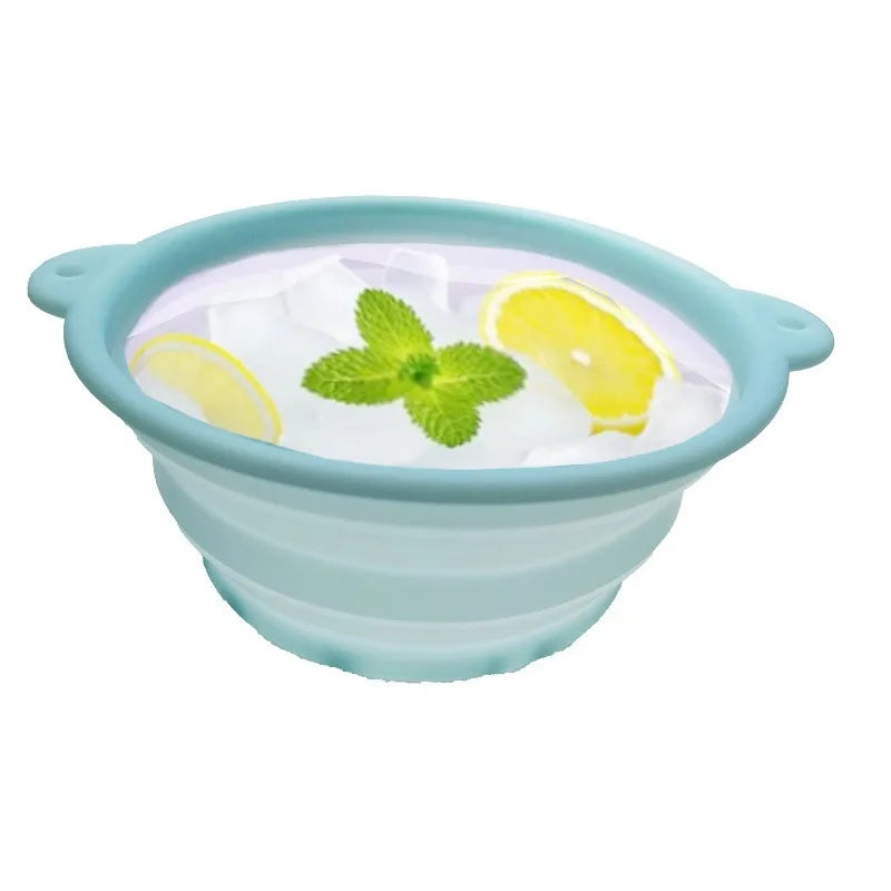 A light blue silicone bowl filled with ice, garnished with mint leaves and a slice of lemon for facial massage.