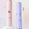 A pink and purple double-headed shaver is shown standing upright against a light background.