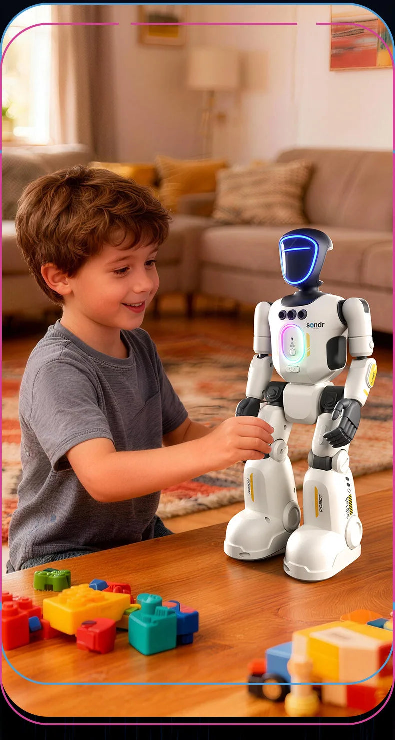 A young boy interacts with a white robot toy while building colorful blocks on a wooden table.