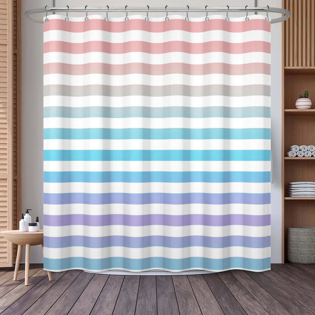 A shower curtain featuring horizontal stripes in shades of pink, beige, blue, and lavender.