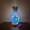 A handcrafted Turkish mosaic table lamp glowing with warm LED light on a dark surface.