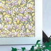 Close-up of a floral pattern in soft lavender and yellow tones on a window film.