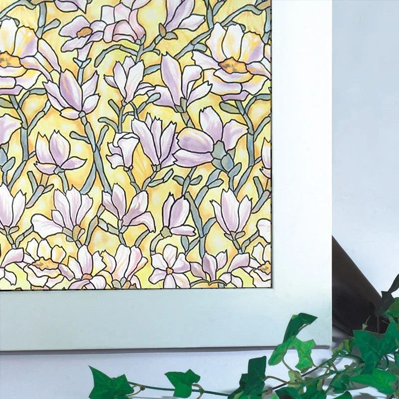 Close-up of a floral pattern in soft lavender and yellow tones on a window film.