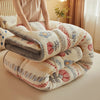 A stack of ultra-soft anti-static plush throw blankets featuring floral patterns in soft beige and gray tones.