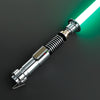 A metallic lightsaber hilt with a glowing green blade is shown against a dark background.