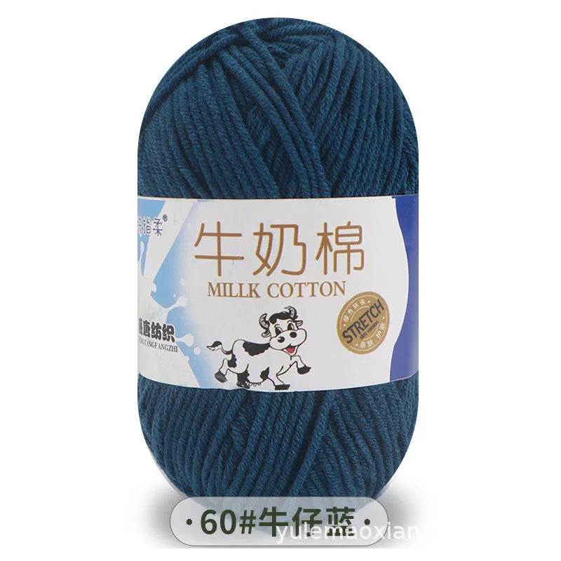 A skein of dark blue milk cotton blend yarn with a label featuring Chinese text and a stretch icon.