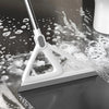 A white silicone squeegee broom is shown cleaning a dark surface, leaving streaks and bubbles.