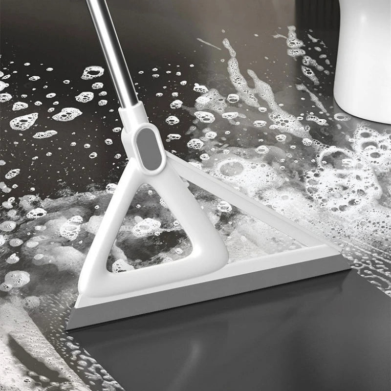 A white silicone squeegee broom is shown cleaning a dark surface, leaving streaks and bubbles.