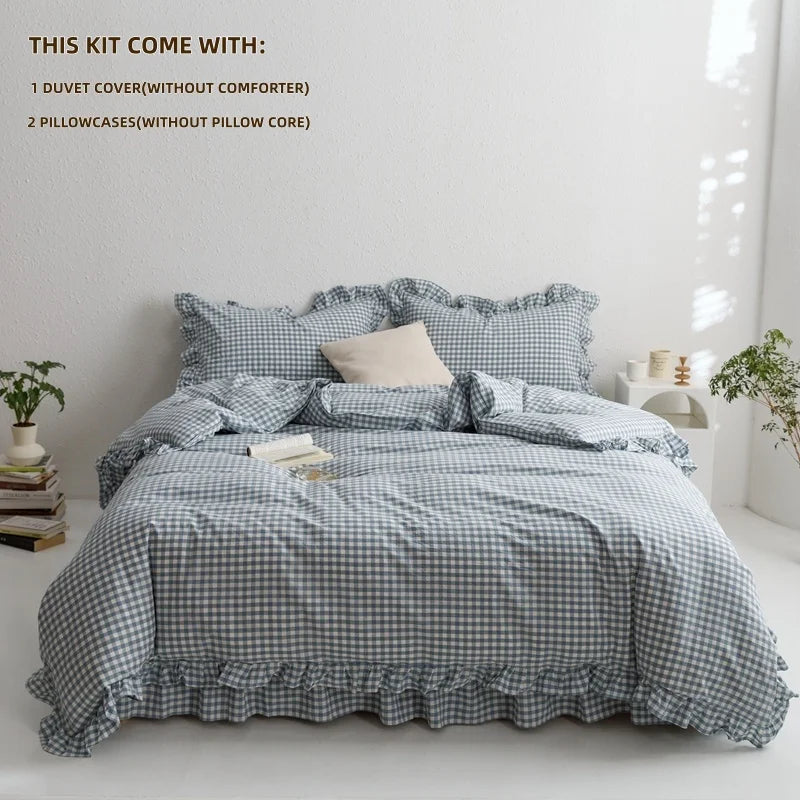 A gray plaid duvet cover set with two pillowcases and a white pillow core shown on a bed.
