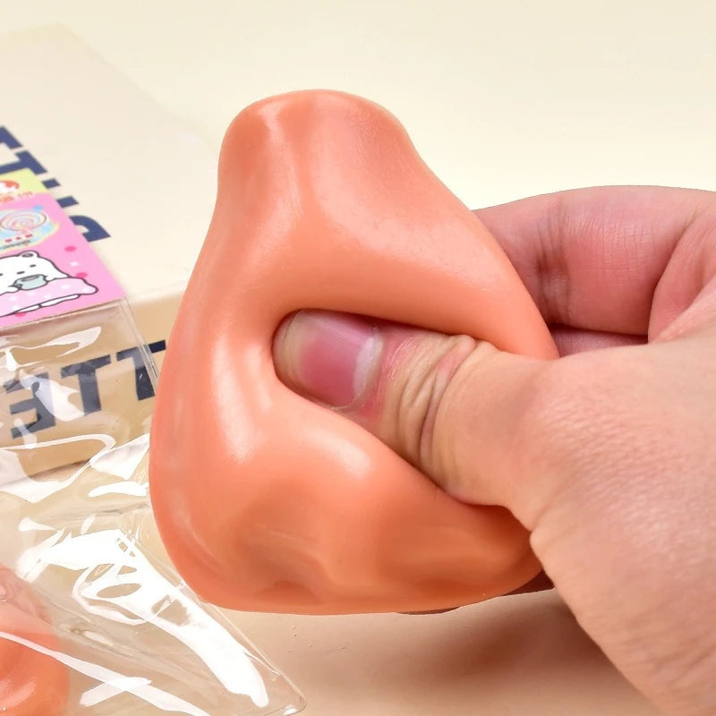 A hand squeezes an orange squishy pimple popper fidget toy for stress relief.