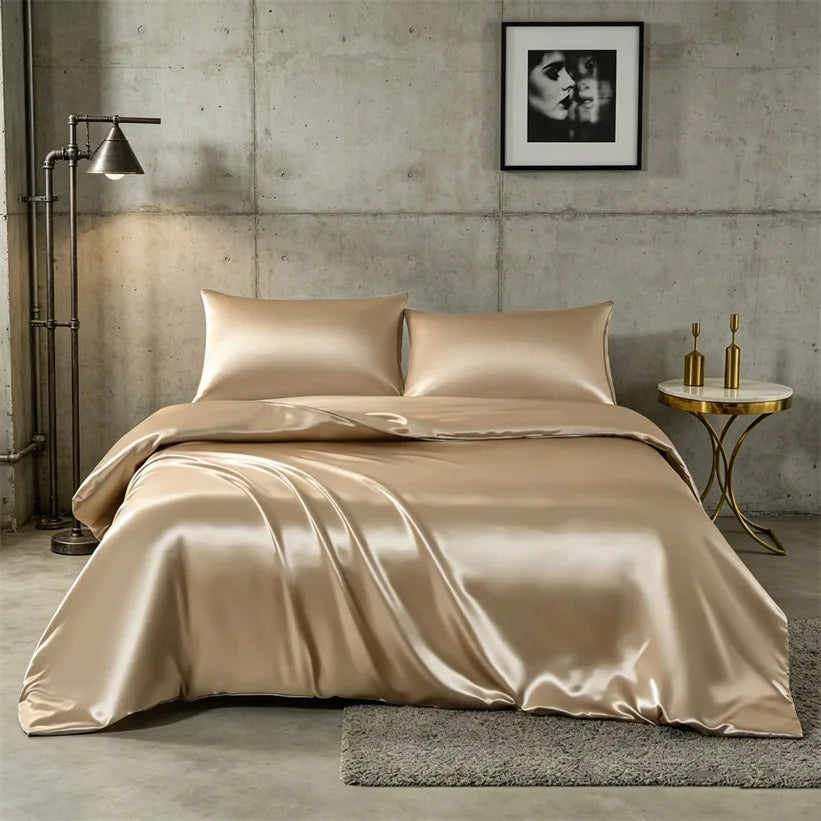 A luxurious champagne silk duvet cover set displayed on a bed in a modern, industrial-style room.