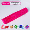 A pink tube of pipe cleaners used for crafts, next to various small craft items.