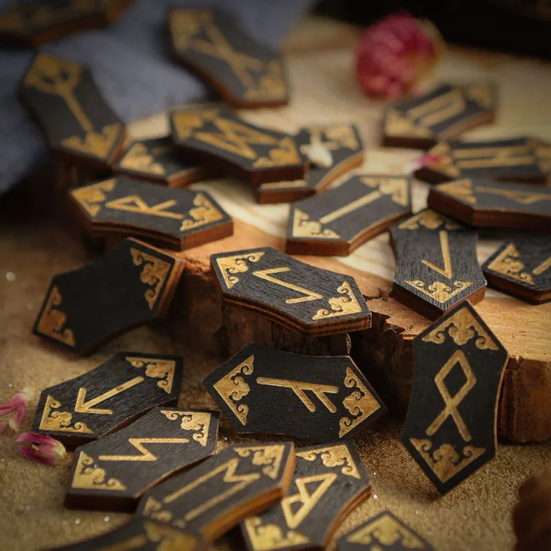 A collection of wooden rune stones and divination tools arranged on a light surface.