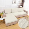 A beige waterproof sofa cushion cover with an elastic edge displayed on a light-colored sofa.